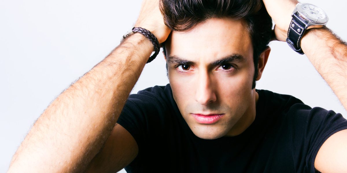 Studio Portrait of beautiful young man posing shampoo